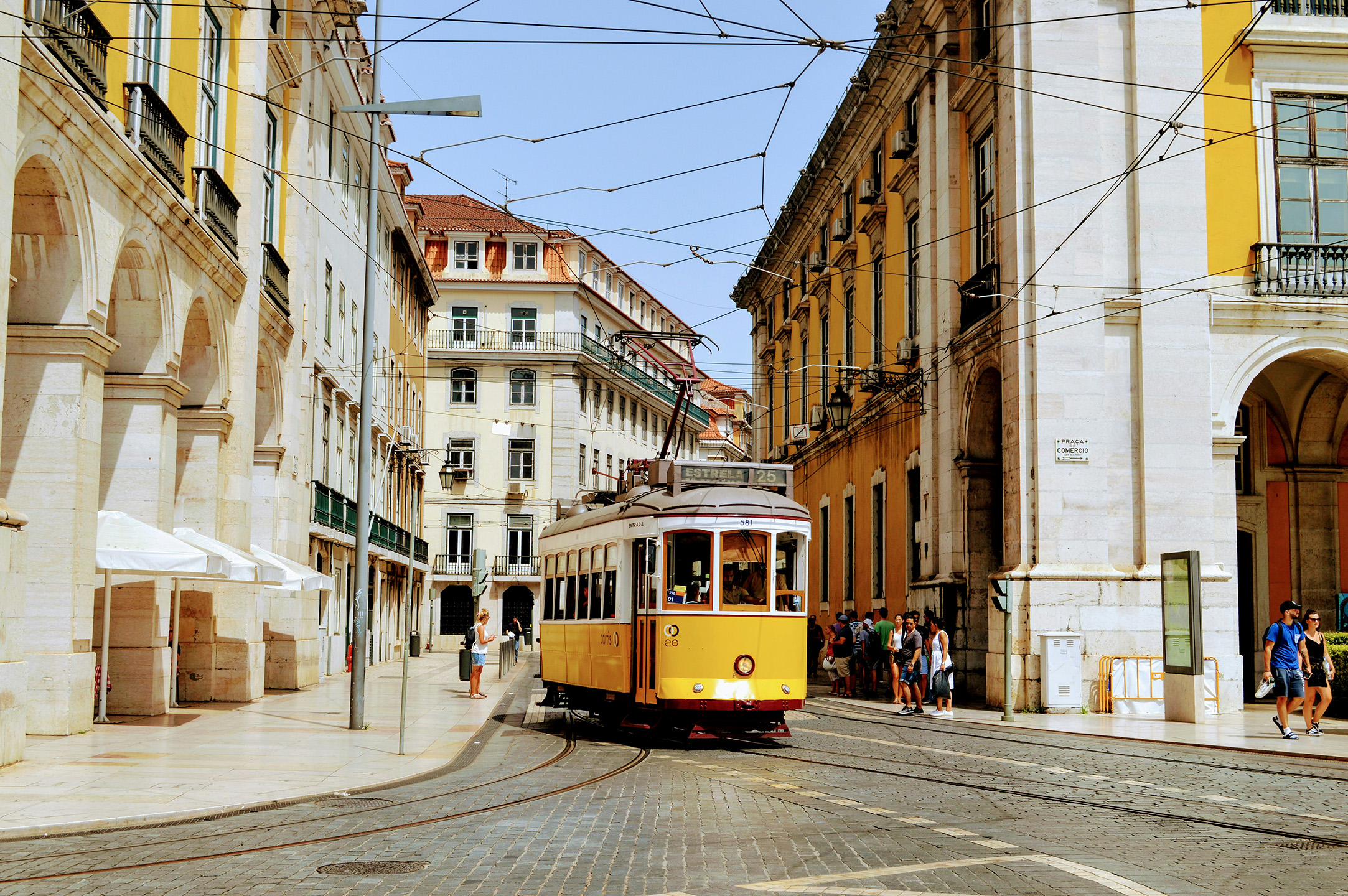 Historic yellow tram in Praça do Comércio, Lisbon