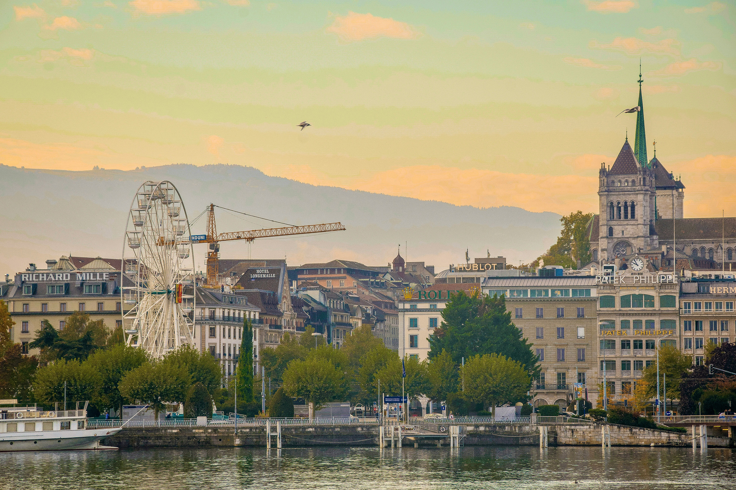 Geneva waterfront at dusk with the Roue de Genève